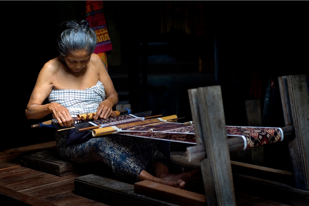 Balinese woman hand weaving Bali Tenun