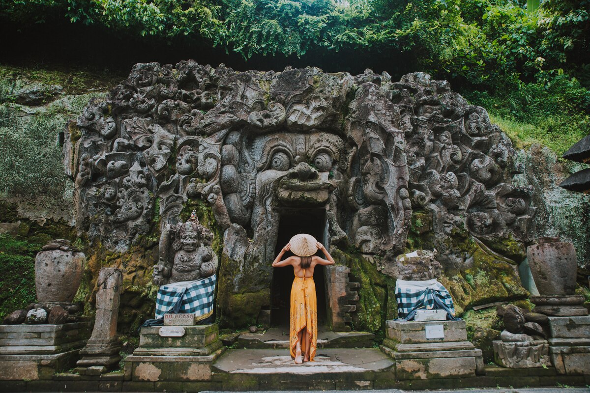 a foreigner looking above at Goa Gajah temple in Bali