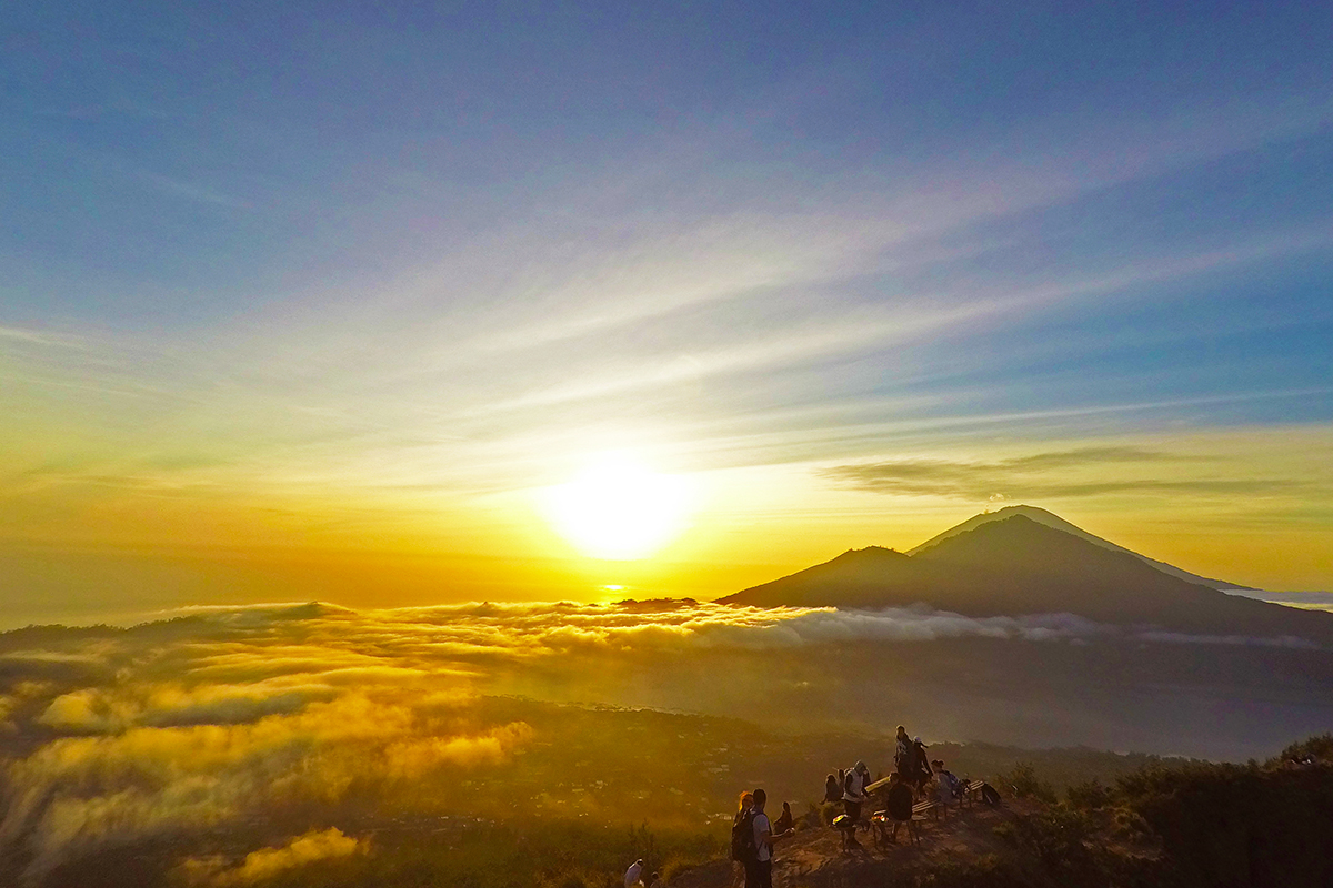 two people looking at a sunrise at Mount Batur